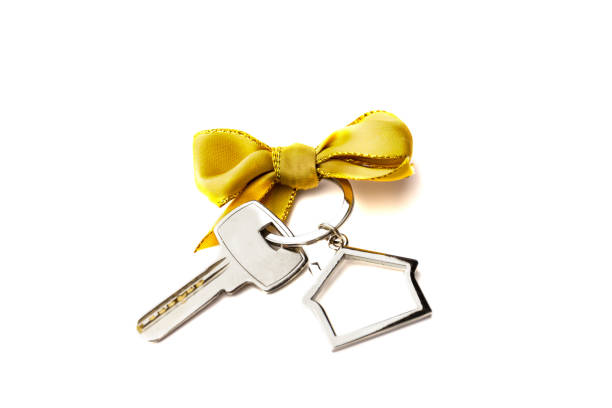 House key with red bow isolated white background