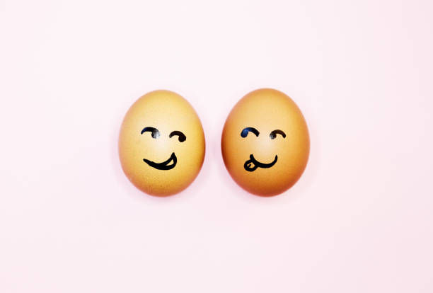 istock Two eggs with cartoon faces seem attracted to each other 1248744839