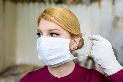 Young woman with face mask protection of Coronavirus.