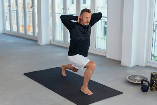 istock Man doing stretch and lunge exercises 1248747002
