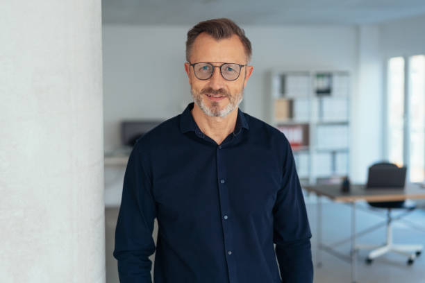 istock Handsome middle-aged man in glasses in office 1248747780