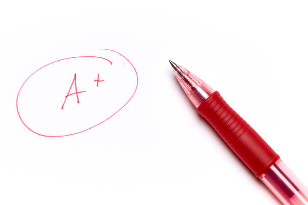 istock One note too many, written in red, on exam paper with the pen on top 1248749612