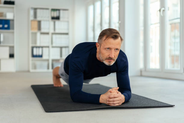 istock Athletic man doing plank exercises in a gym 1248749695