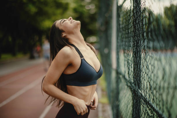 Carefree athletic woman with eyes closed enjoying after a great training