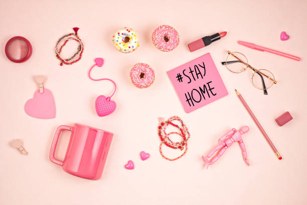 istock Flat lay with pink accessories, tea cup and donuts over light pink background. Top view. Morning rituals, stay at home idea 1248750039
