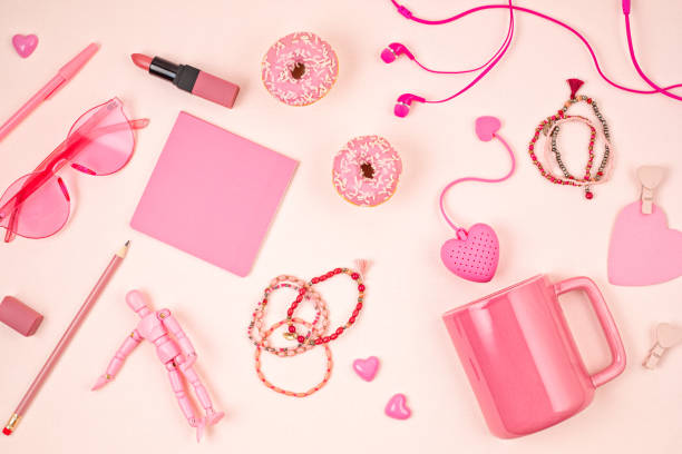 istock Flat lay with pink accessories, tea cup and donuts over light pink background. Top view. Morning rituals, stay at home idea 1248750152