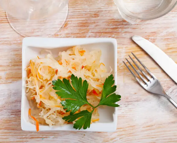Photo of Homemade sauerkraut on white plate