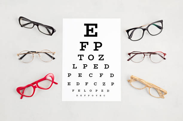 istock Collection of eyeglasses with eye test table. Optical store, glasses selection, eye test, vision examination at optician, fashion accessories concept. Top view 1248750434