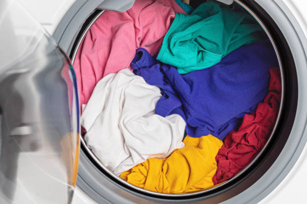 istock Washing or drying machine loaded with the laundry. Washing, spring cleaning idea 1248750535