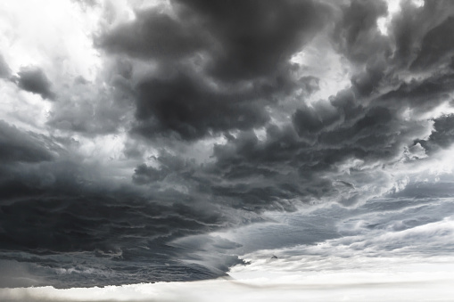 Supercell thunderstorm. Dramatic black clouds and motion. Dark sky with thunderstorm before rainy.