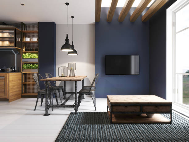 istock Area with a TV in a studio apartment with a loft style kitchen. Wooden designer dining table and modern kitchen. 1248753425