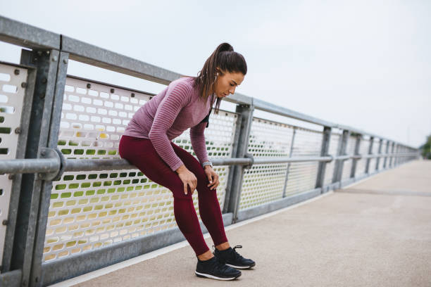 istock Female athlete resting from jogging outdoors 1248755174