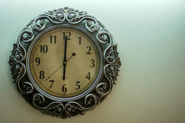 istock Ancient Wall Designer Wall Clock With Light Yellow Back Ground showing time 06.00 o'clock 1248755273