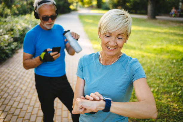 istock Senior woman using smart watch while exercising outdoors 1248755845