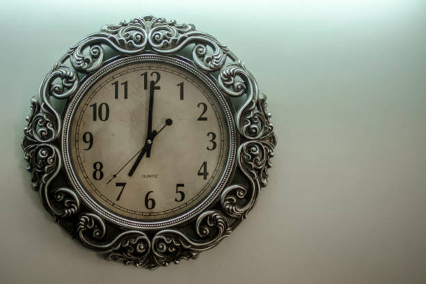 istock Ancient Wall Designer Wall Clock With Light Yellow Back Ground showing time 07.00 o'clock 1248755891