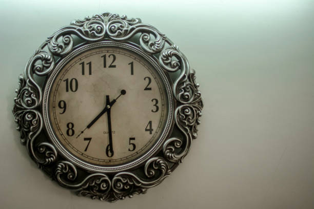 istock Ancient Wall Designer Wall Clock With Light Yellow Back Ground showing time 07.30 o'clock 1248755985
