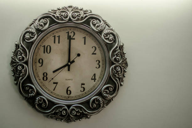 istock Ancient Wall Designer Wall Clock With Light Yellow Back Ground showing time 08.00 o'clock 1248756122