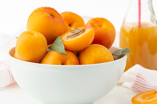 Wicker birch basket with fresh juicy candied oranges with fresh juicy orange and sugar on a light gray background