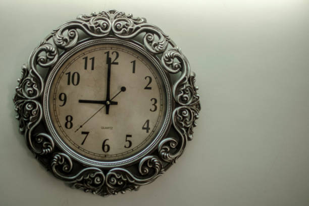 istock Ancient Wall Designer Wall Clock With Light Yellow Back Ground showing time 09.00 o'clock 1248757126
