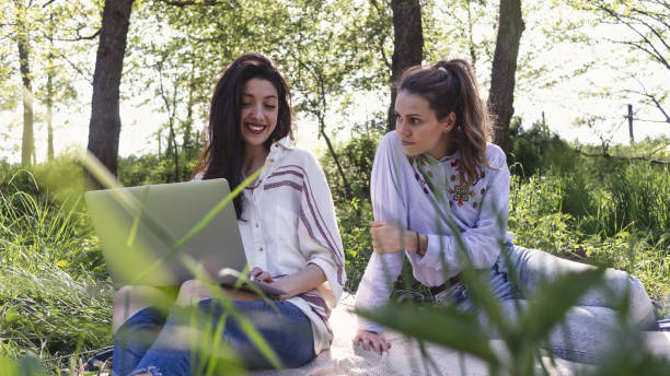 istock Two freelancer women working at the park 1248757225