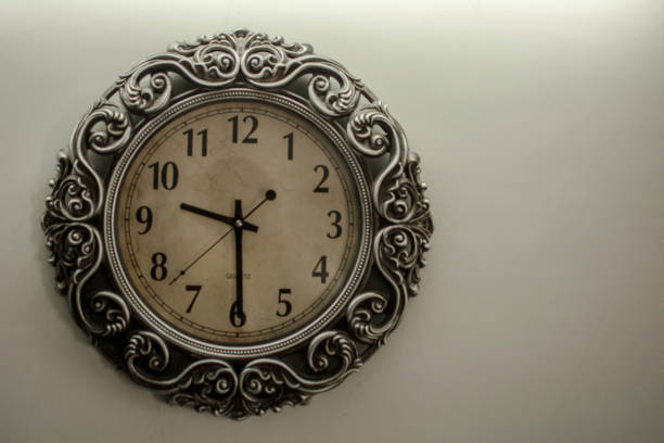 istock Ancient Wall Designer Wall Clock With Light Yellow Back Ground showing time 09.30 o'clock 1248757386