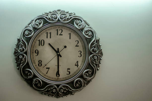 istock Ancient Wall Designer Wall Clock With Light Yellow Back Ground showing time 10.30 o'clock 1248757513