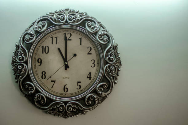 istock Ancient Wall Designer Wall Clock With Light Yellow Back Ground showing time 11.00 o'clock 1248757590
