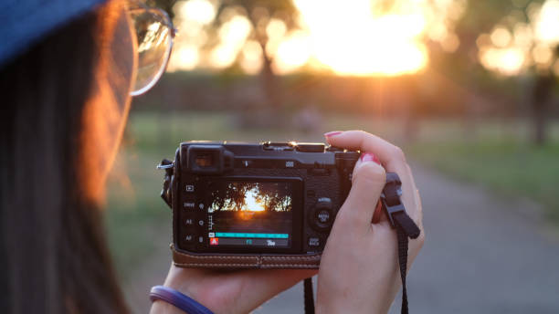 istock Young and beautiful girl taking photographs with a camera 1248758846