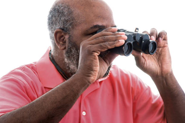 istock African American man looking through binoculars on white background 1248758902