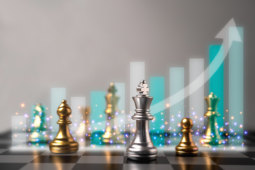Selective focus of chess and growth business graph behind chess. World map in the background. The concept of the key success of business and finance is an analysis and strategy with professional.