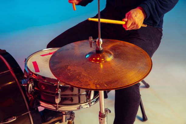 istock Caucasian male drummer improvising isolated on blue studio background in neon light 1248760328