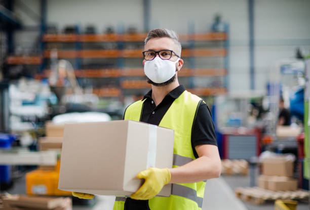 istock Man worker with protective mask working in industrial factory or warehouse. 1248760725