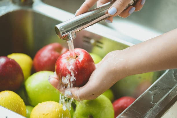istock ripe and juicy apples,hands wash apples under running water 1248761302