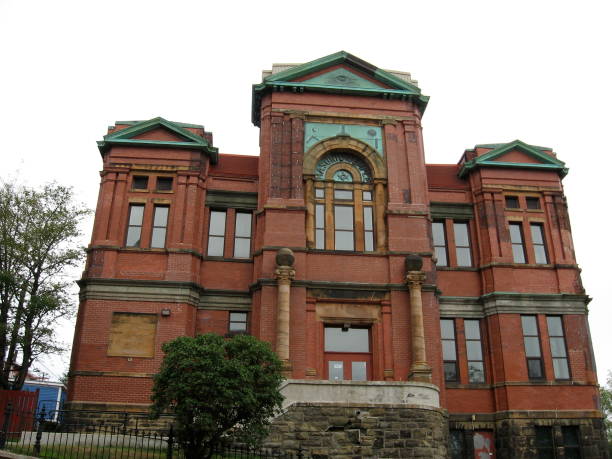 Looking up at red brick Masonic temple in St. John’s