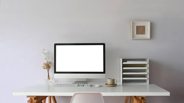istock Comfortable workspace computer monitor is putting on a white working desk surrounded by office equipment. 1248763844