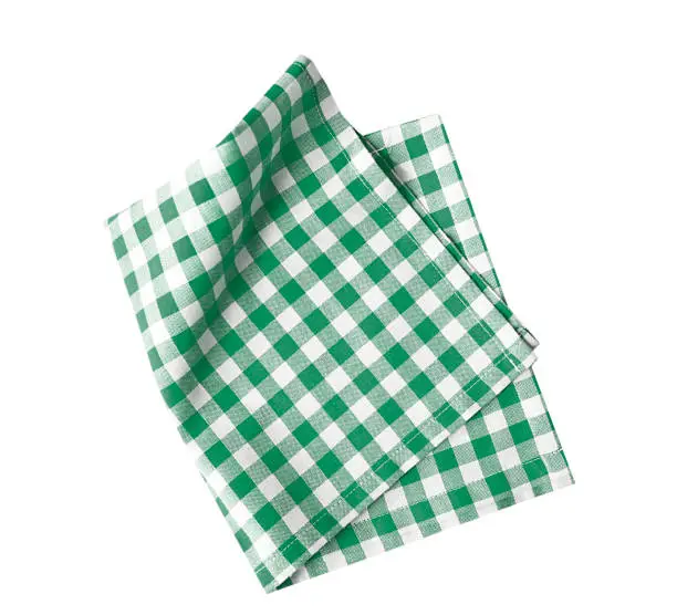 Photo of Green checkered folded cloth isolated,kitchen picnic towel top view.