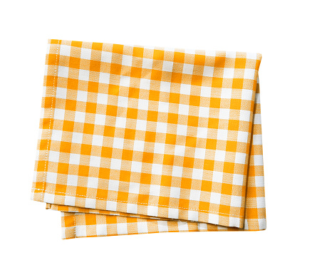 Tela doblada a cuadros amarilla aislada, toalla de picnic de cocina. photo