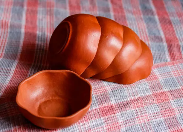 top view of hand made mud crockery in cloth background