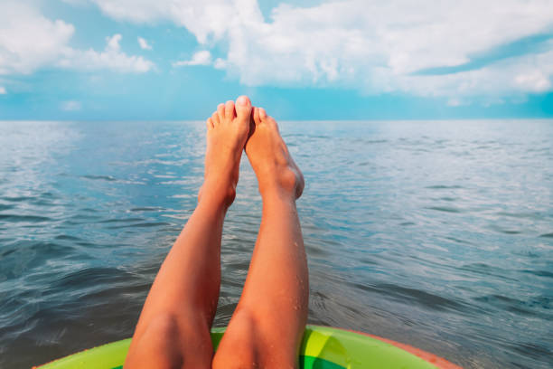 istock relax on beach vacation-kids feet on floatie at sea 1248764737