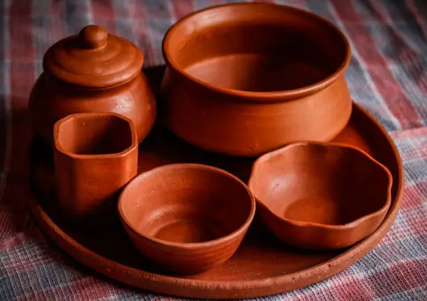 top view of hand made mud crockery in cloth background