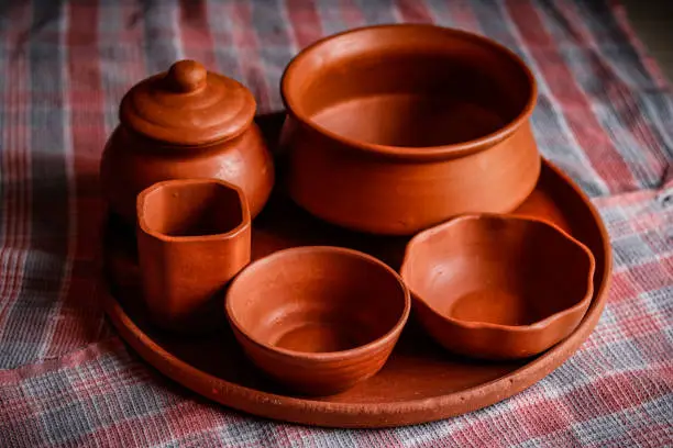 top view of hand made mud crockery in cloth background