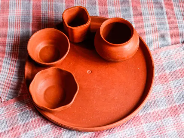 top view of hand made mud crockery in cloth background