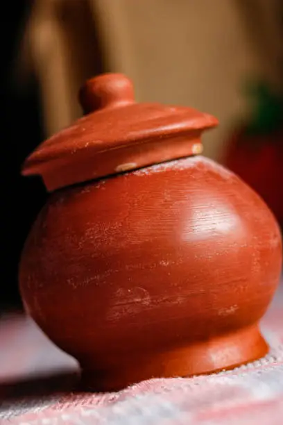 side view of hand made mud crockery in cloth background
