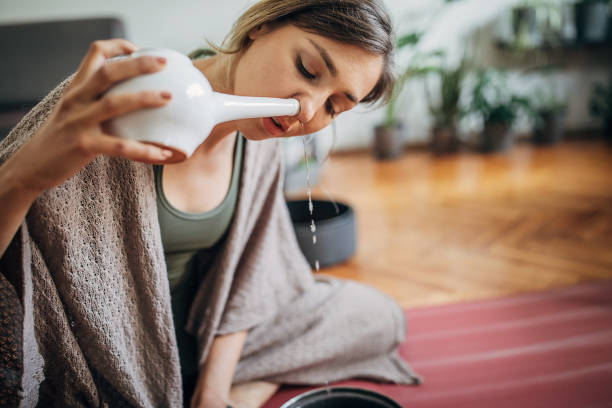 istock Beautiful woman using neti pot 1248766327