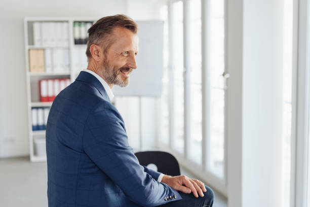 istock Relaxed stylish businessman perched on his desk 1248767669