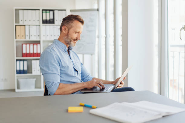 istock Businessman working at a handheld laptop 1248767704
