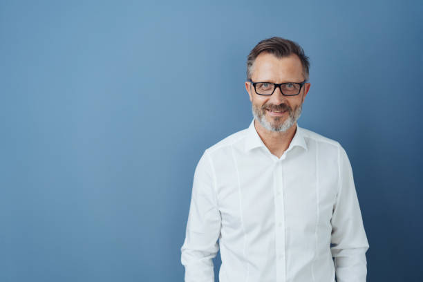 istock Smiling man in glasses and white shirt, copy space 1248767731