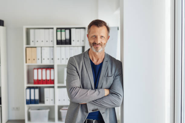 istock Confident relaxed businessman leaning against wall 1248768424