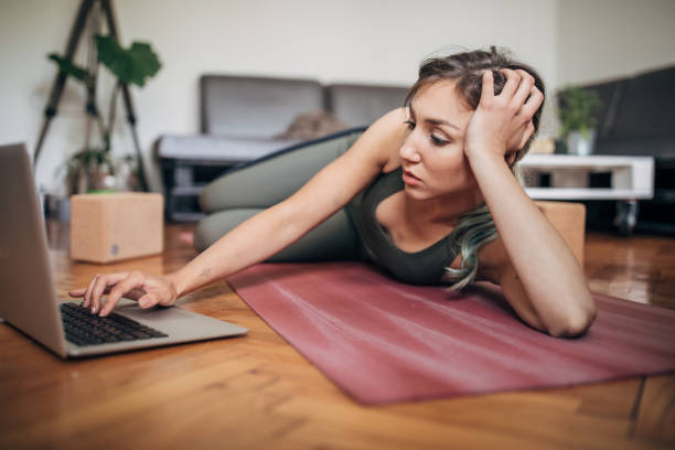 istock Beautiful woman using laptop on the floor at home 1248768525
