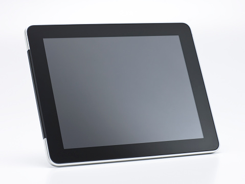 Generic Tablet Computer with Blank Screen isolated on White Background. Real Shadow. Angle View with Copy Space for Text or Image